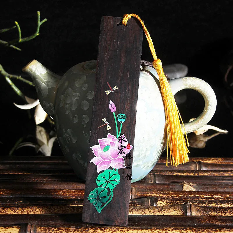Chinese style painted lotus bookmark made from sandalwood with landscape flower decoration.