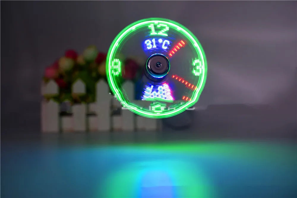 Silver USB clock temperature fan with LED display and metal flexible neck on a desk