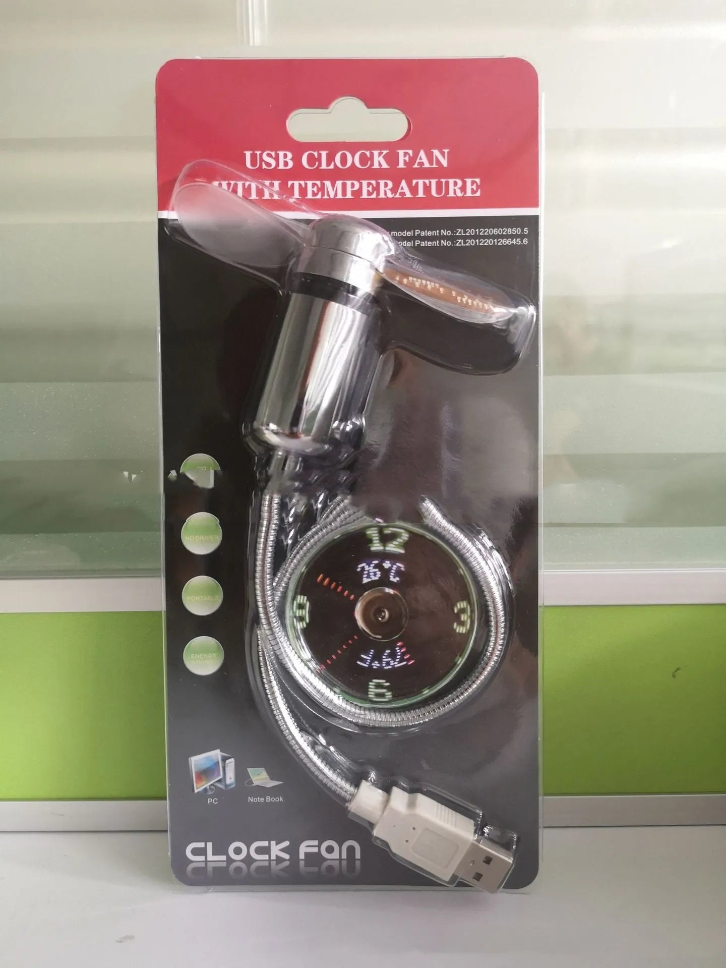 Silver USB clock temperature fan with LED display and metal flexible neck on a desk