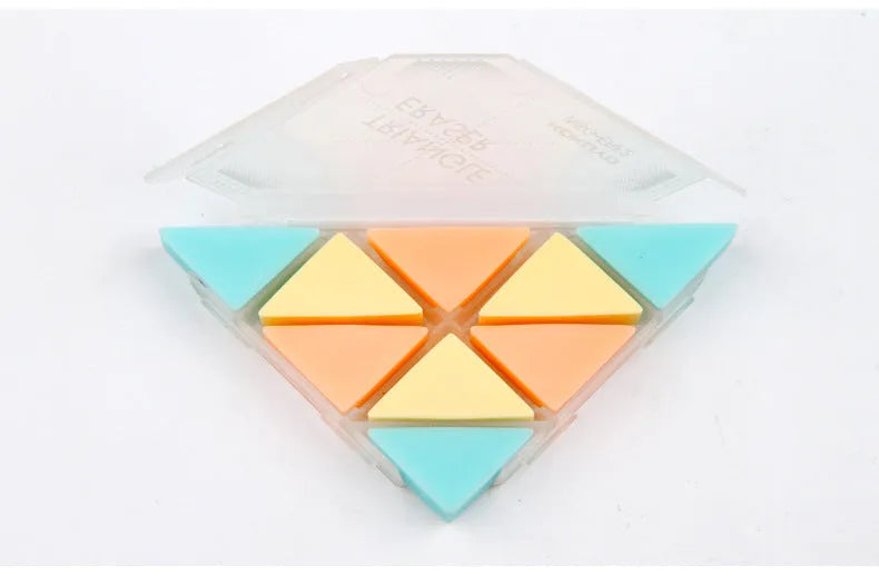 A blue PVC triangle eraser on a wooden desk, showing its three sharp corners for detail work.
