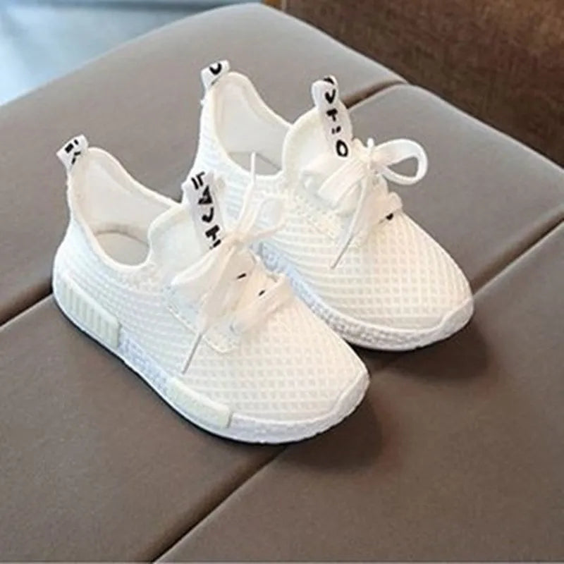 Mesh girls primary school sneakers in white with front tie laces and rubber sole