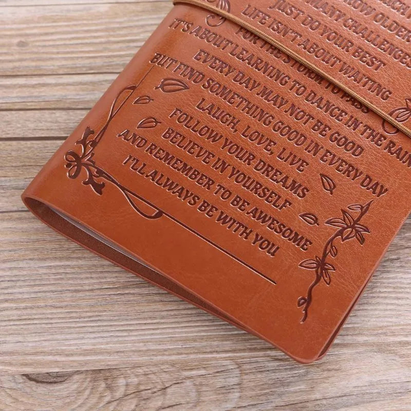 Leather hand ledger notebook with strap binding showing warm brown acid-free paper