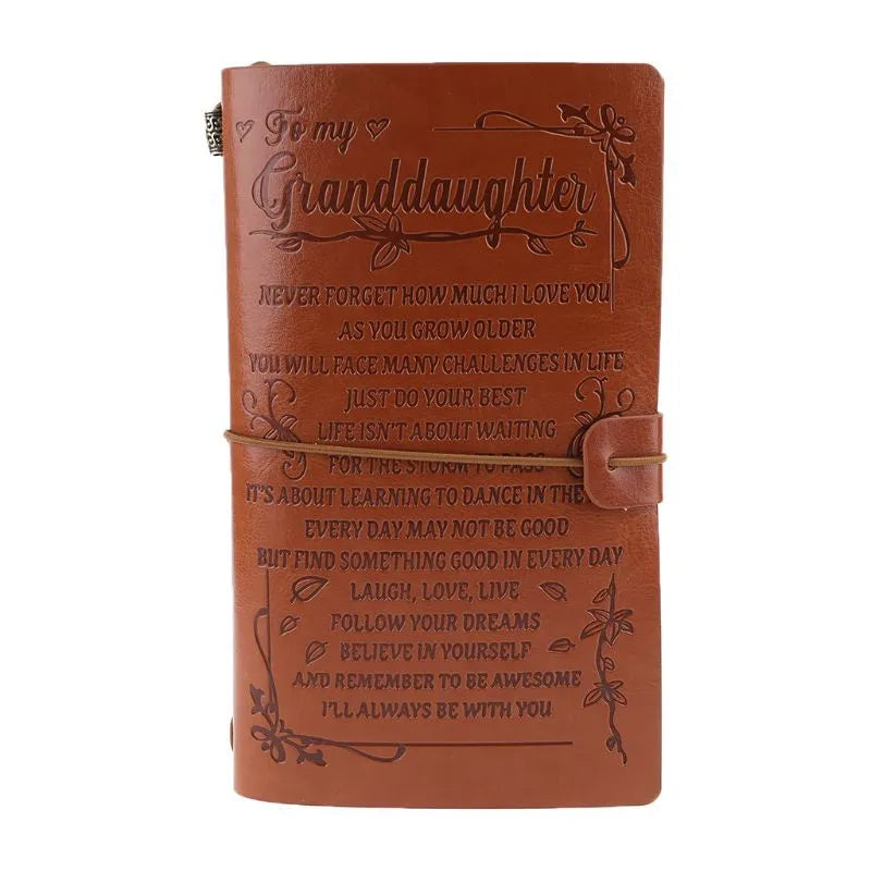 Leather hand ledger notebook with strap binding showing warm brown acid-free paper