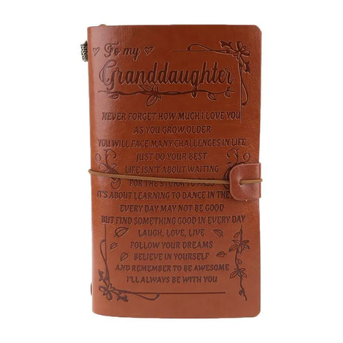 Leather hand ledger notebook with strap binding showing warm brown acid-free paper