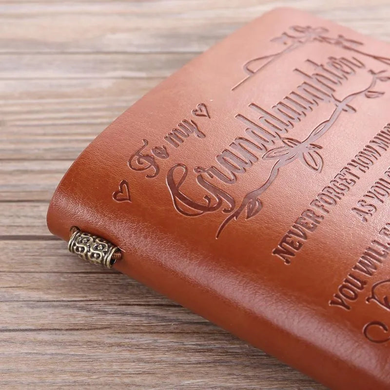 Leather hand ledger notebook with strap binding showing warm brown acid-free paper