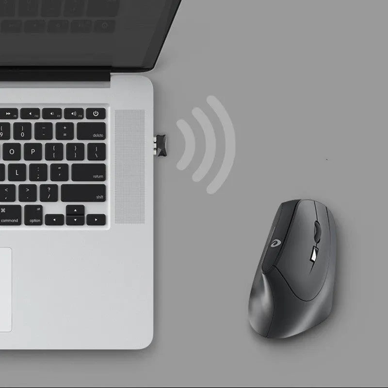 Black vertical ergonomic wireless mouse with 2.4G USB receiver on a desk