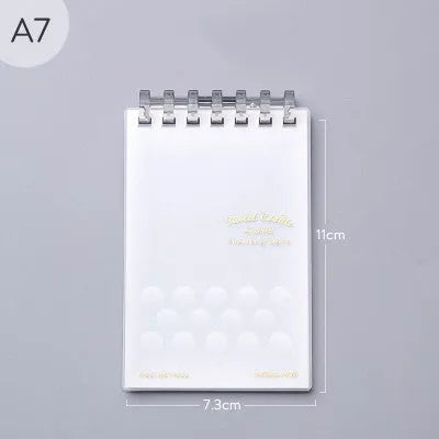 A7 detachable coil notebook with hard cover showing multiple loose-leaf paper types including timeline, checkered and blank formats