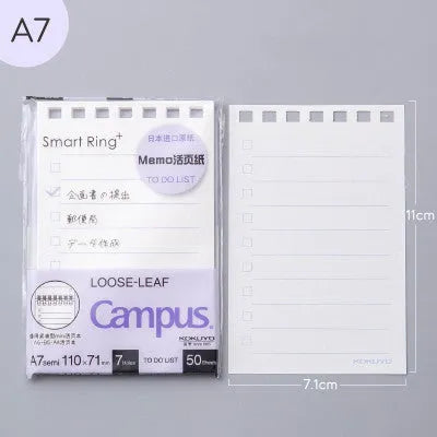 A7 detachable coil notebook with hard cover showing multiple loose-leaf paper types including timeline, checkered and blank formats