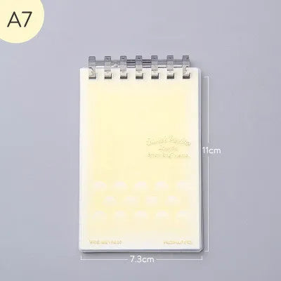 A7 detachable coil notebook with hard cover showing multiple loose-leaf paper types including timeline, checkered and blank formats