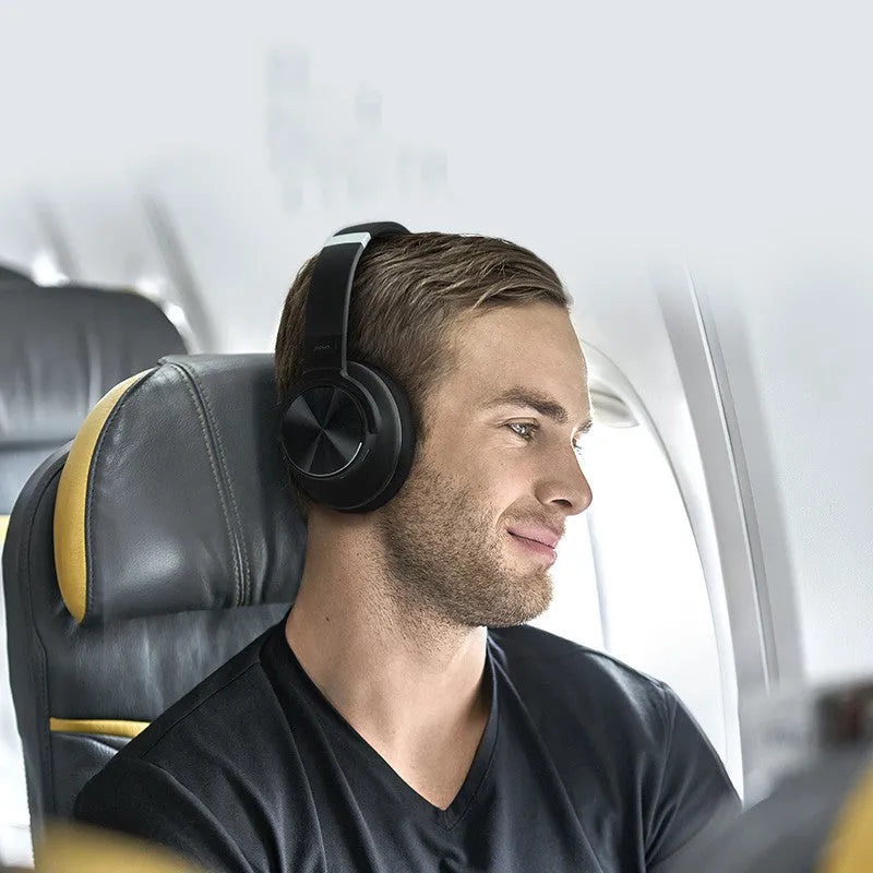 Cold black Bluetooth wireless headset with active noise cancellation and all-in-ear design