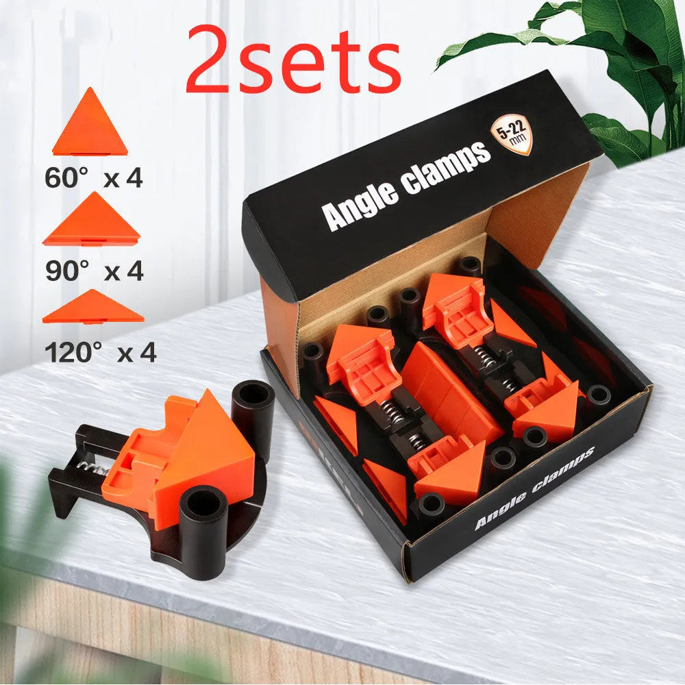 Set of four white plastic right angle clamps for picture frame assembly on a wooden surface.