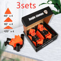 Set of four white plastic right angle clamps for picture frame assembly on a wooden surface.