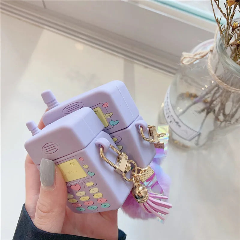 Purple silicone case for Apple AirPods with fur ball pendant showing clamshell design