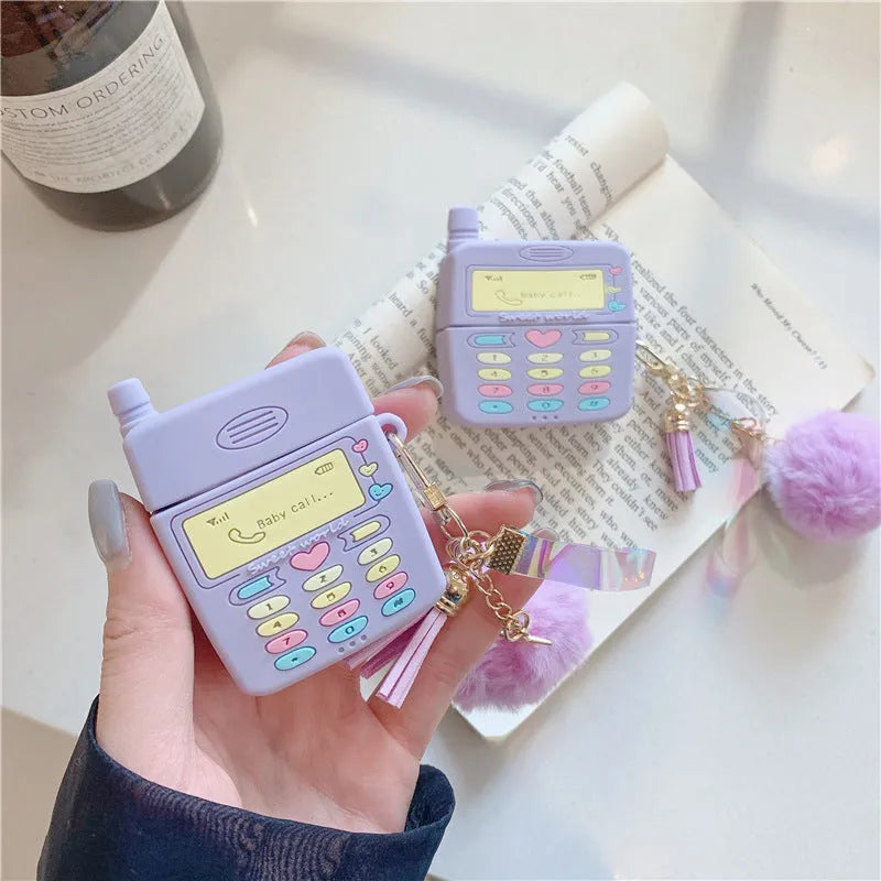Purple silicone case for Apple AirPods with fur ball pendant showing clamshell design