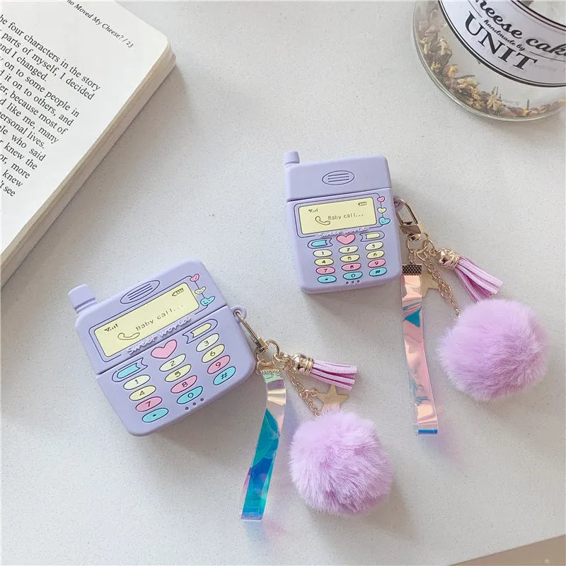 Purple silicone case for Apple AirPods with fur ball pendant showing clamshell design