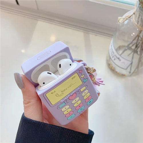 Purple silicone case for Apple AirPods with fur ball pendant showing clamshell design