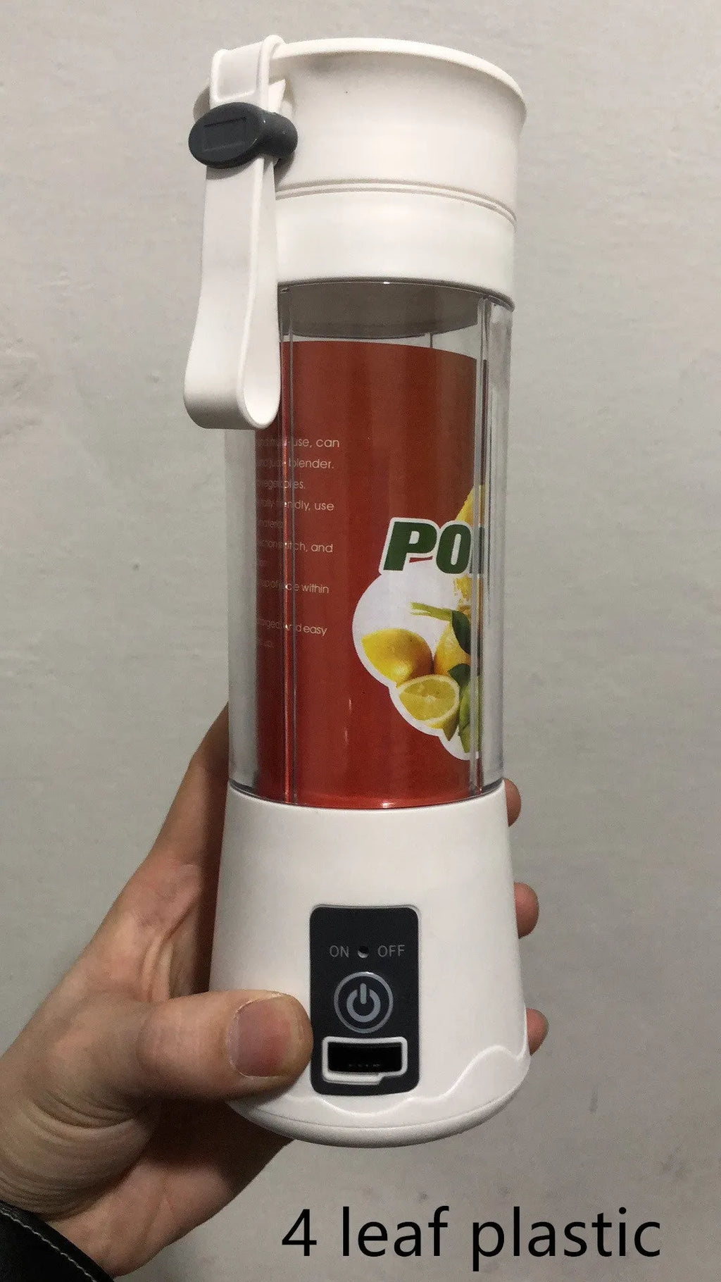 Pink mini USB electric fruit juicer with carrying rope on a kitchen countertop.