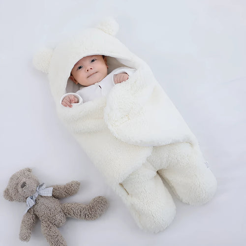 A baby quilted sleeping bag wrapper in a plain colour, showing its quilted pattern and soft cotton blend fabric.