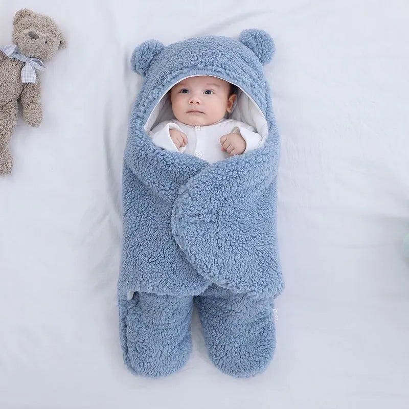 A baby quilted sleeping bag wrapper in a plain colour, showing its quilted pattern and soft cotton blend fabric.