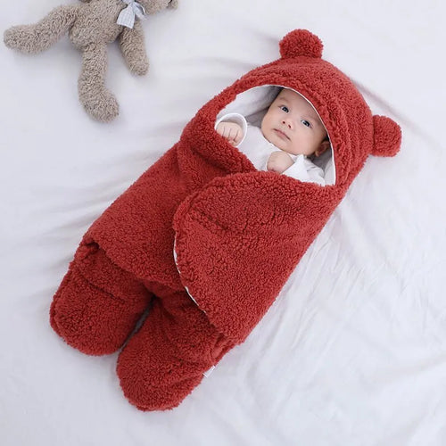 A baby quilted sleeping bag wrapper in a plain colour, showing its quilted pattern and soft cotton blend fabric.