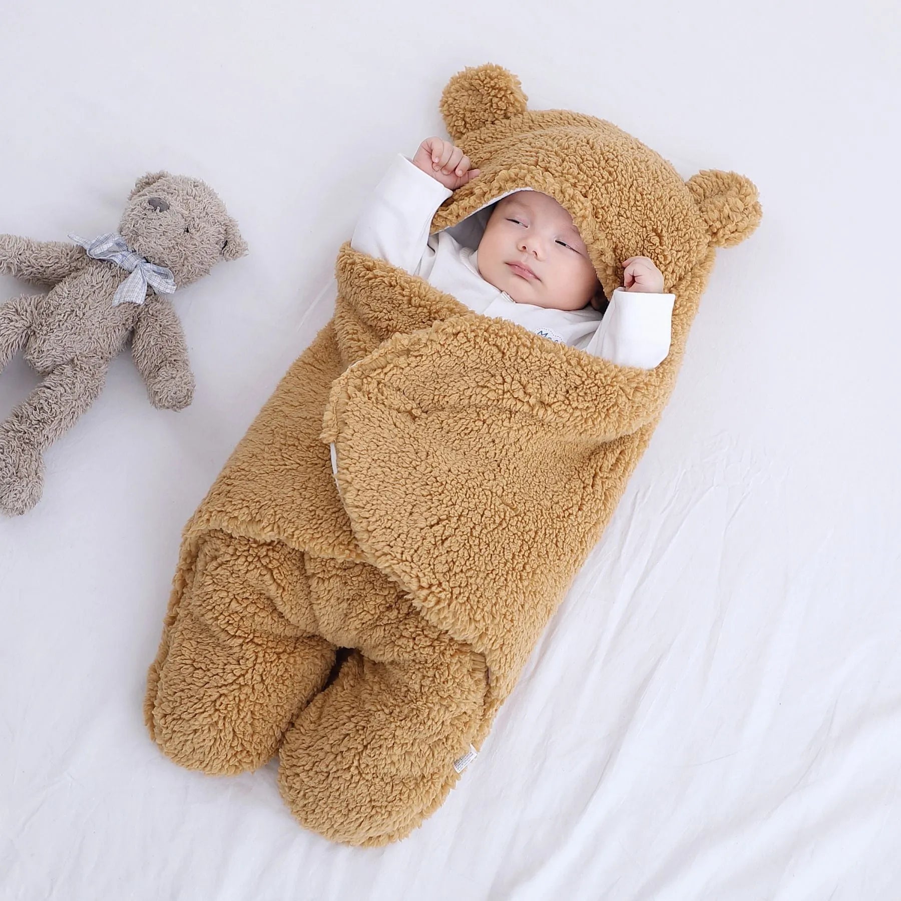 A baby quilted sleeping bag wrapper in a plain colour, showing its quilted pattern and soft cotton blend fabric.