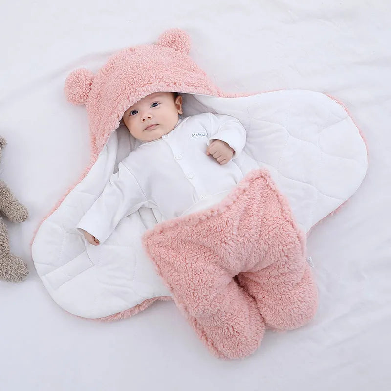 A baby quilted sleeping bag wrapper in a plain colour, showing its quilted pattern and soft cotton blend fabric.