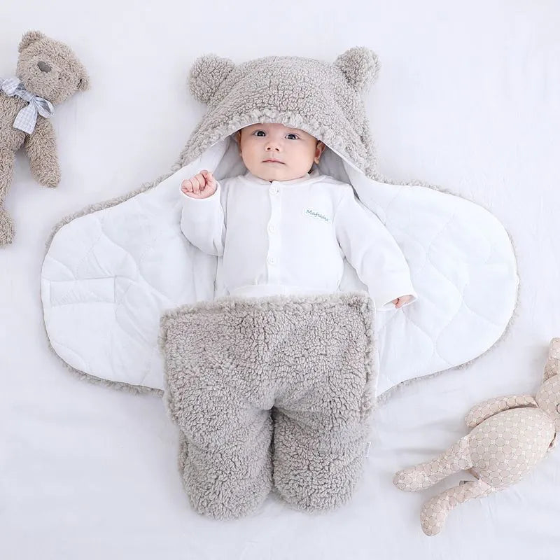 A baby quilted sleeping bag wrapper in a plain colour, showing its quilted pattern and soft cotton blend fabric.