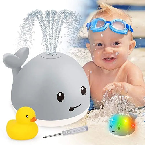 Grey or white whale bath toy floating in water with LED lights and water spray fountain
