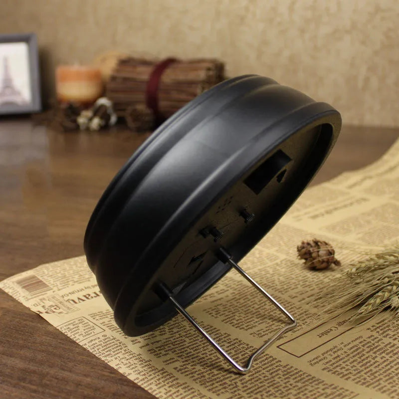 Round 6-inch retro-style desk alarm clock with silent sweep movement in a vintage colour on a wooden surface.
