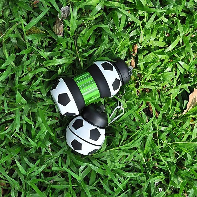 White collapsible soccer ball silicone water bottle with straw and black carrying clip on white background
