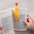 Creative silicone screaming chicken bookmark in yellow on an open book page showing its 16 cm length