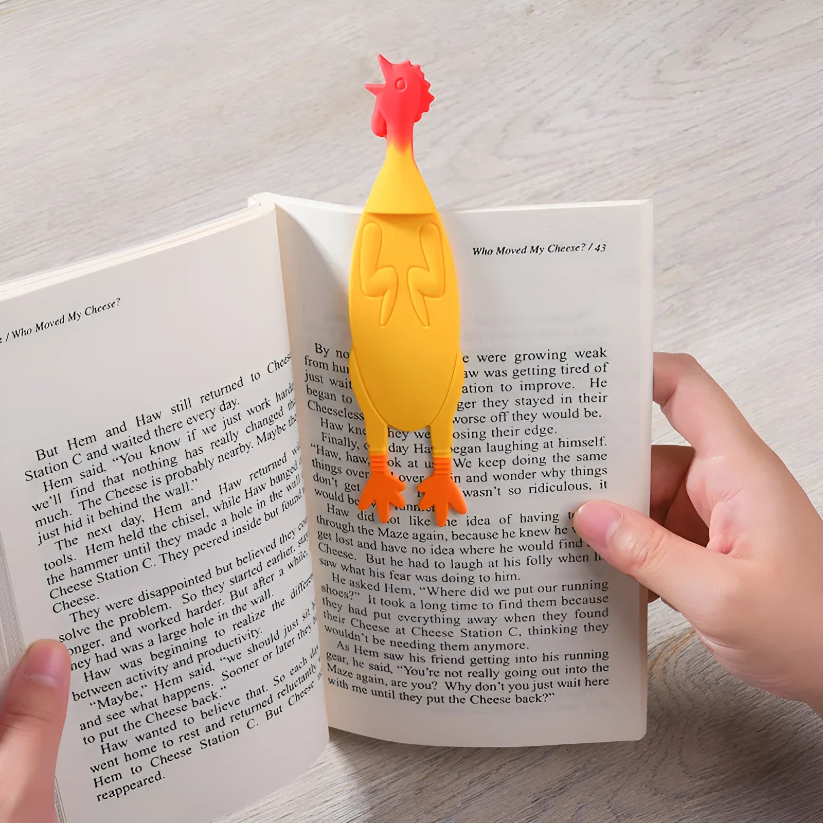Creative silicone screaming chicken bookmark in yellow on an open book page showing its 16 cm length