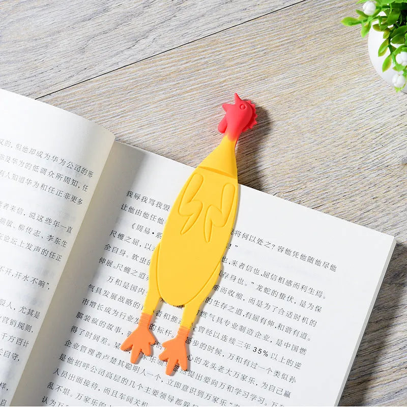 Creative silicone screaming chicken bookmark in yellow on an open book page showing its 16 cm length