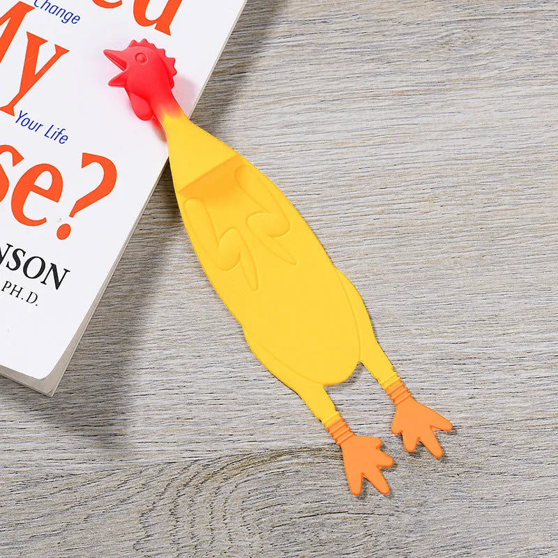 Creative silicone screaming chicken bookmark in yellow on an open book page showing its 16 cm length