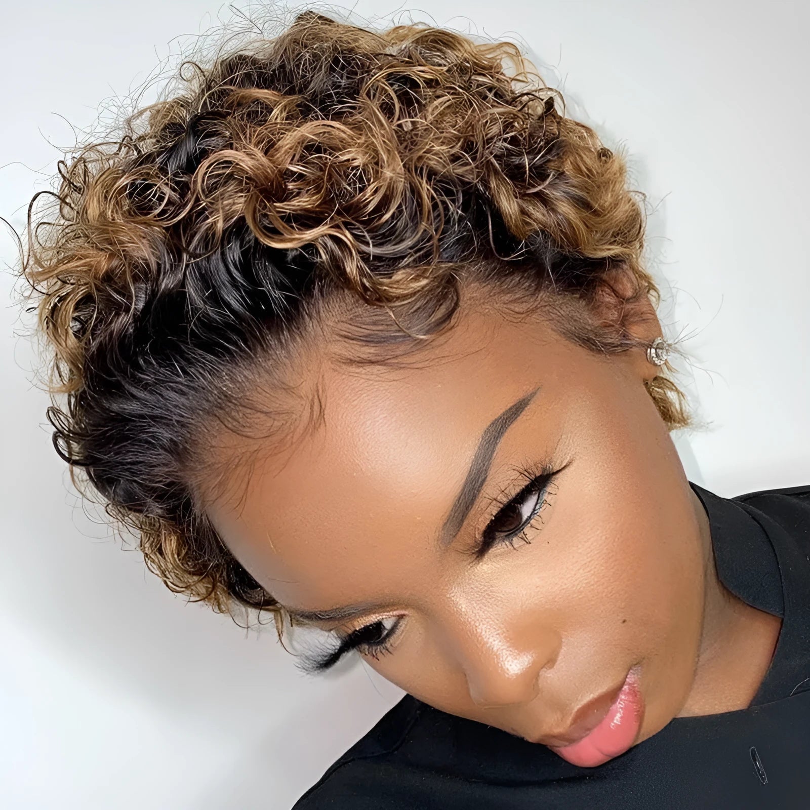 Black African small curly hair wig with fluffy explode style and long bangs on a mannequin head