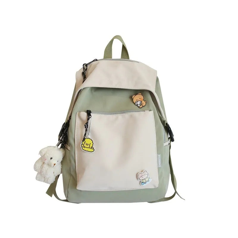Korean style college backpack in pink without pendant, water repellent, 20-35L capacity on plain background