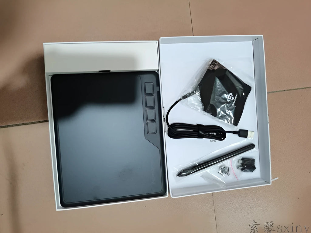 Gaoman S620 black digital drawing board with USB cable and stylus pen on desk
