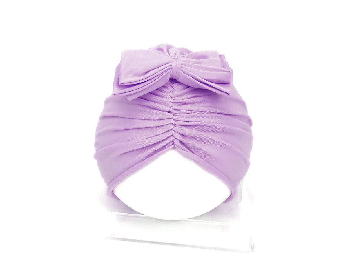 Soft acrylic knitted baby hat in a solid colour, shown on a mannequin head, suitable for newborns and infants.