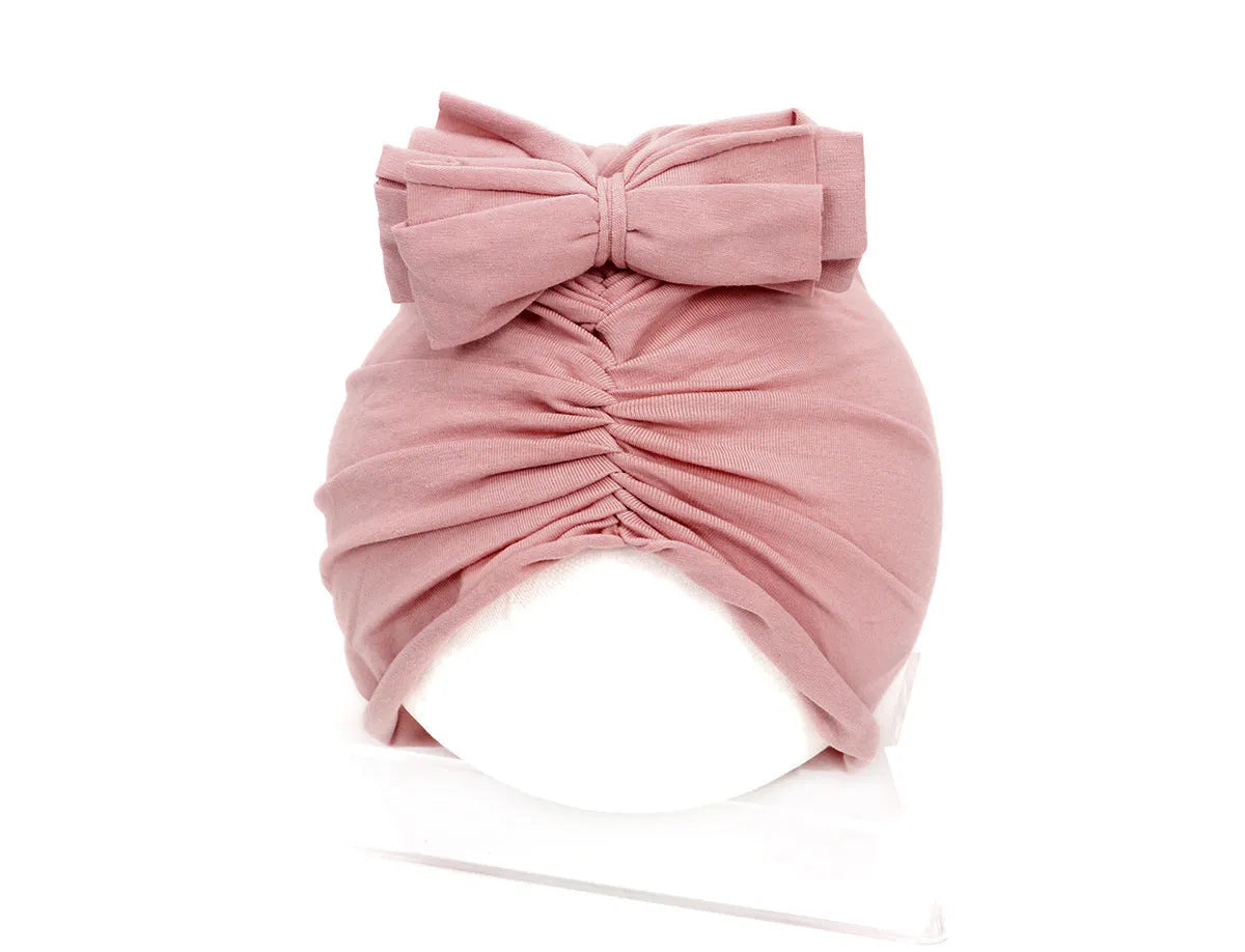 Soft acrylic knitted baby hat in a solid colour, shown on a mannequin head, suitable for newborns and infants.