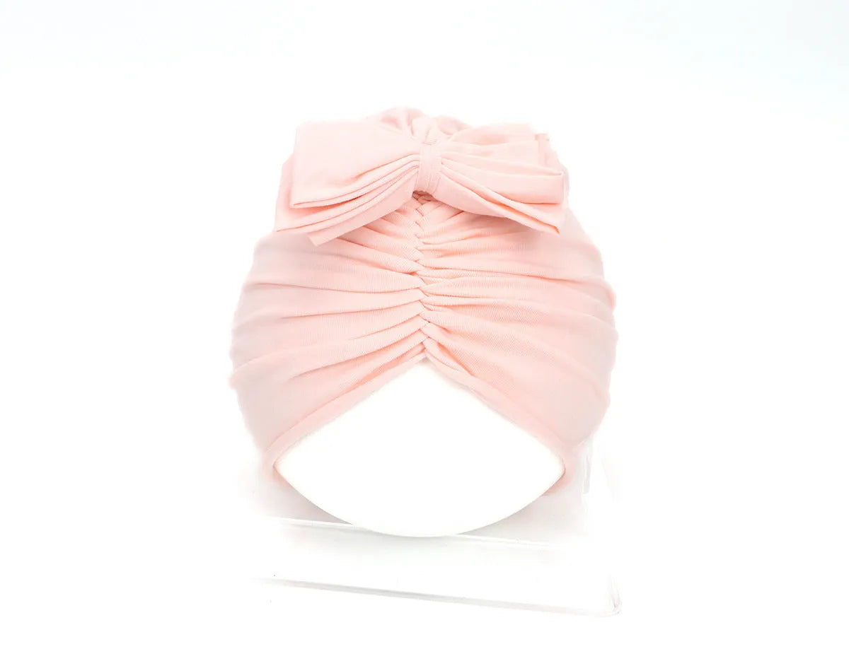Soft acrylic knitted baby hat in a solid colour, shown on a mannequin head, suitable for newborns and infants.