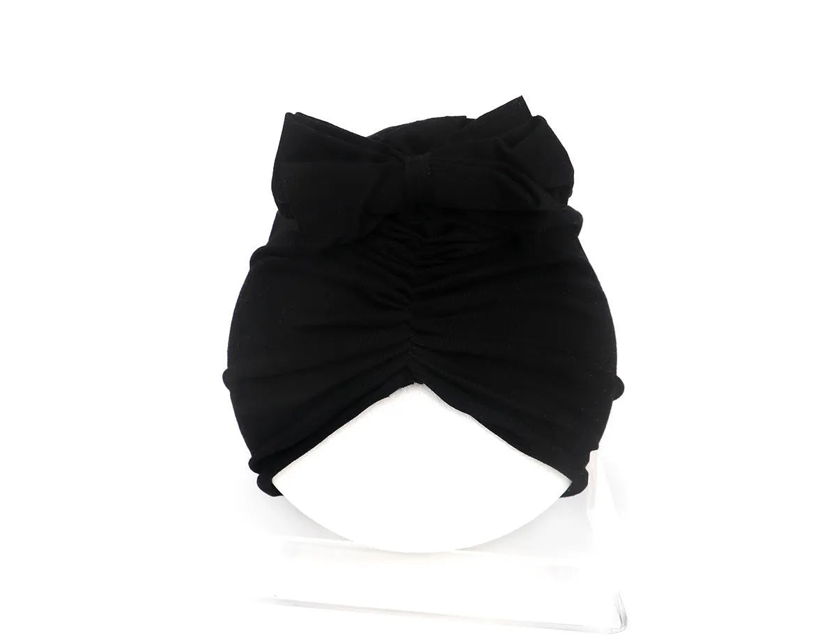Soft acrylic knitted baby hat in a solid colour, shown on a mannequin head, suitable for newborns and infants.
