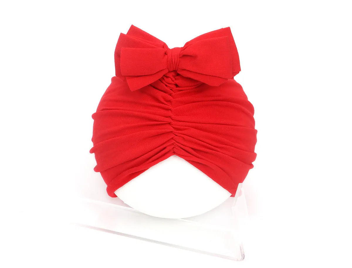 Soft acrylic knitted baby hat in a solid colour, shown on a mannequin head, suitable for newborns and infants.