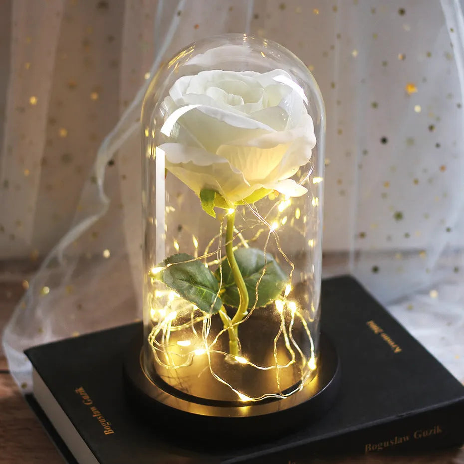 Artificial silk rose LED ornament with glass lampshade showing warm white lights, available in multiple colours.