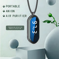Portable negative ion air purifier in pearl white with metal lanyard and USB cable on a desk