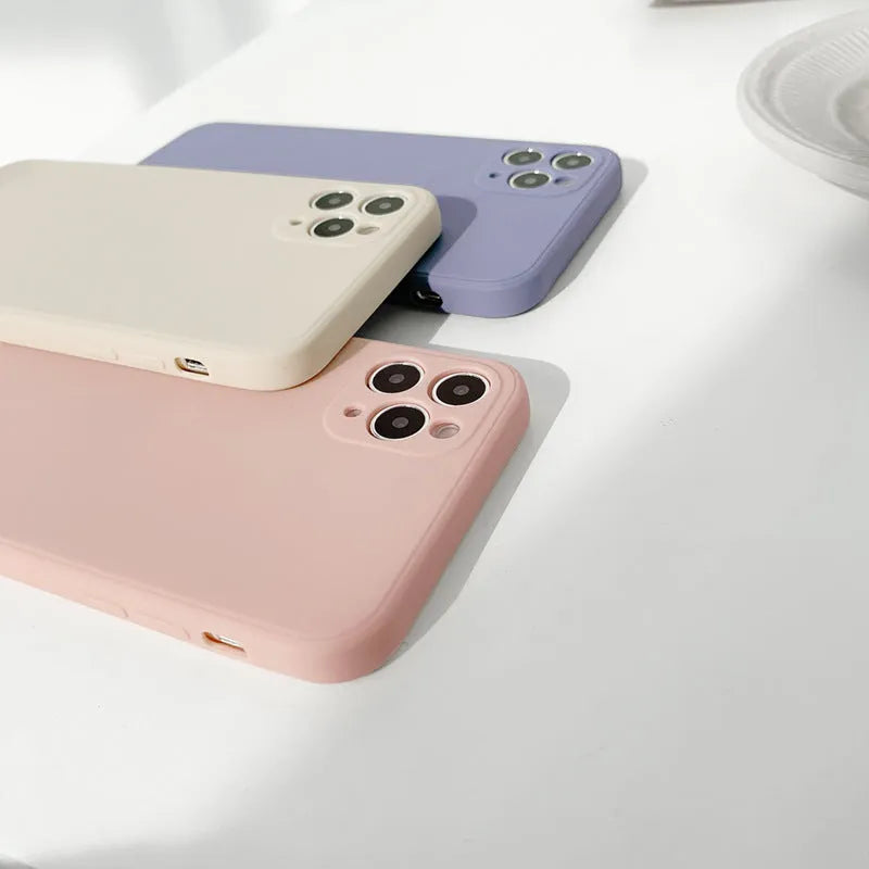 Simple solid colour silicone iPhone case in powder, slate blue or antique white on an iPhone.