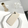 Simple solid colour silicone iPhone case in powder, slate blue or antique white on an iPhone.