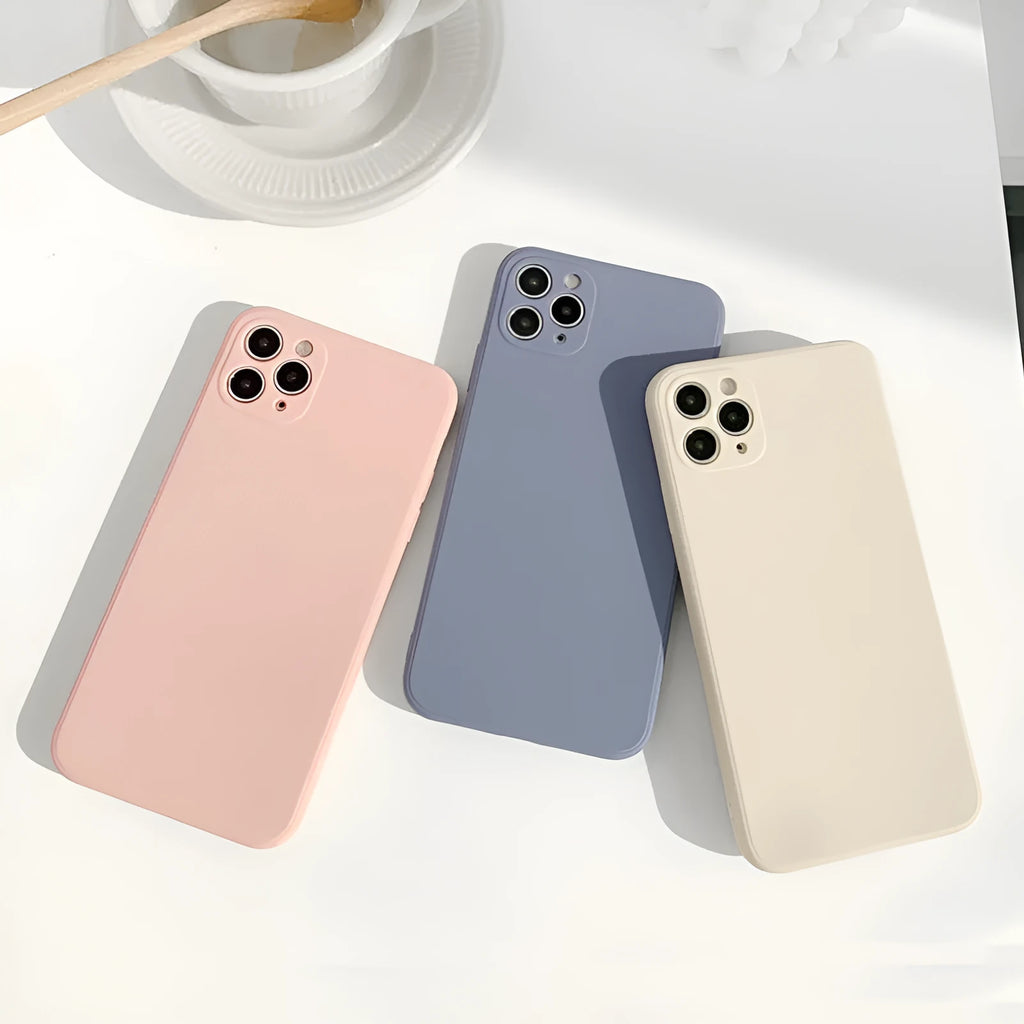 Simple solid colour silicone iPhone case in powder, slate blue or antique white on an iPhone.