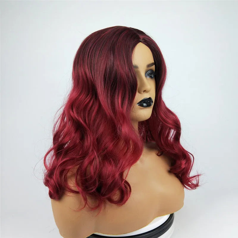 Burgundy long curly wig with big wavy gradient colour and centre bangs on a mannequin
