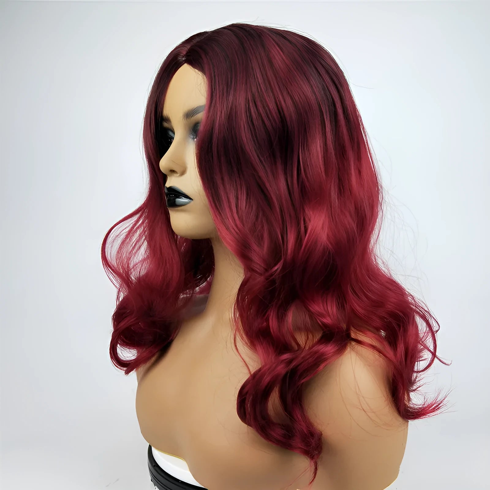 Burgundy long curly wig with big wavy gradient colour and centre bangs on a mannequin