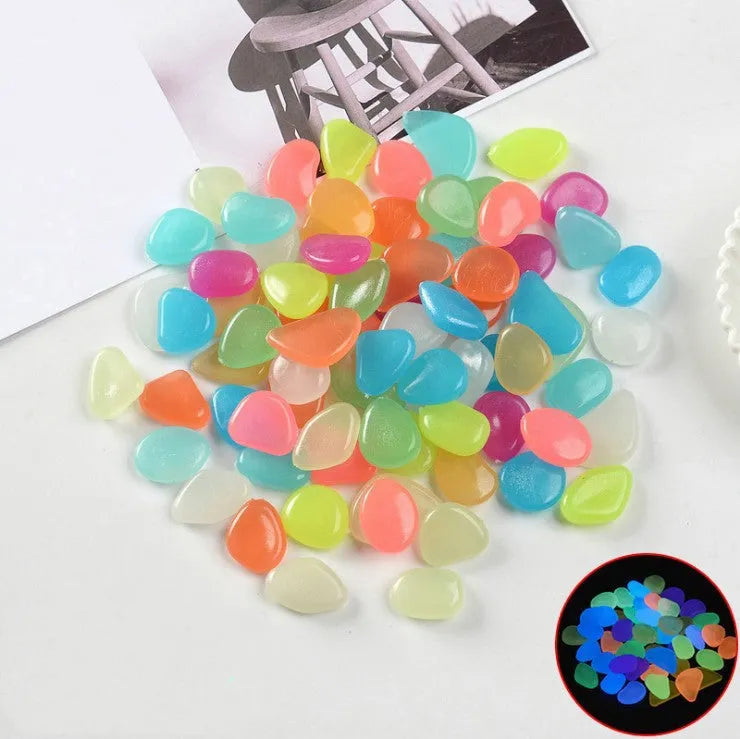 Luminous fluorescent aquarium and garden pebbles in mixed colours including dark purple, yellow, light blue, pink, orange